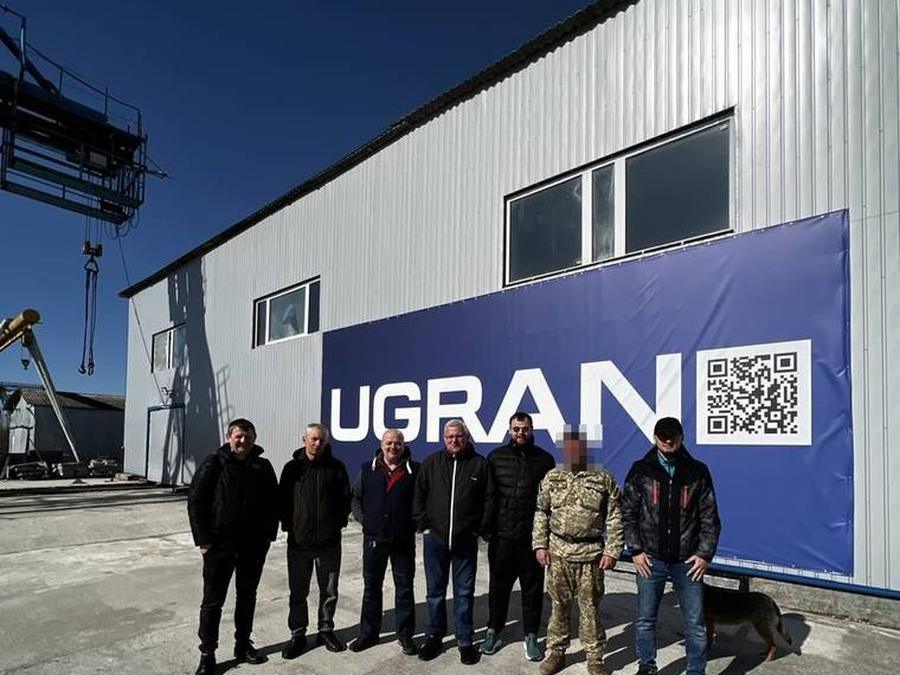 The UGRAN plant team in front of the company banner